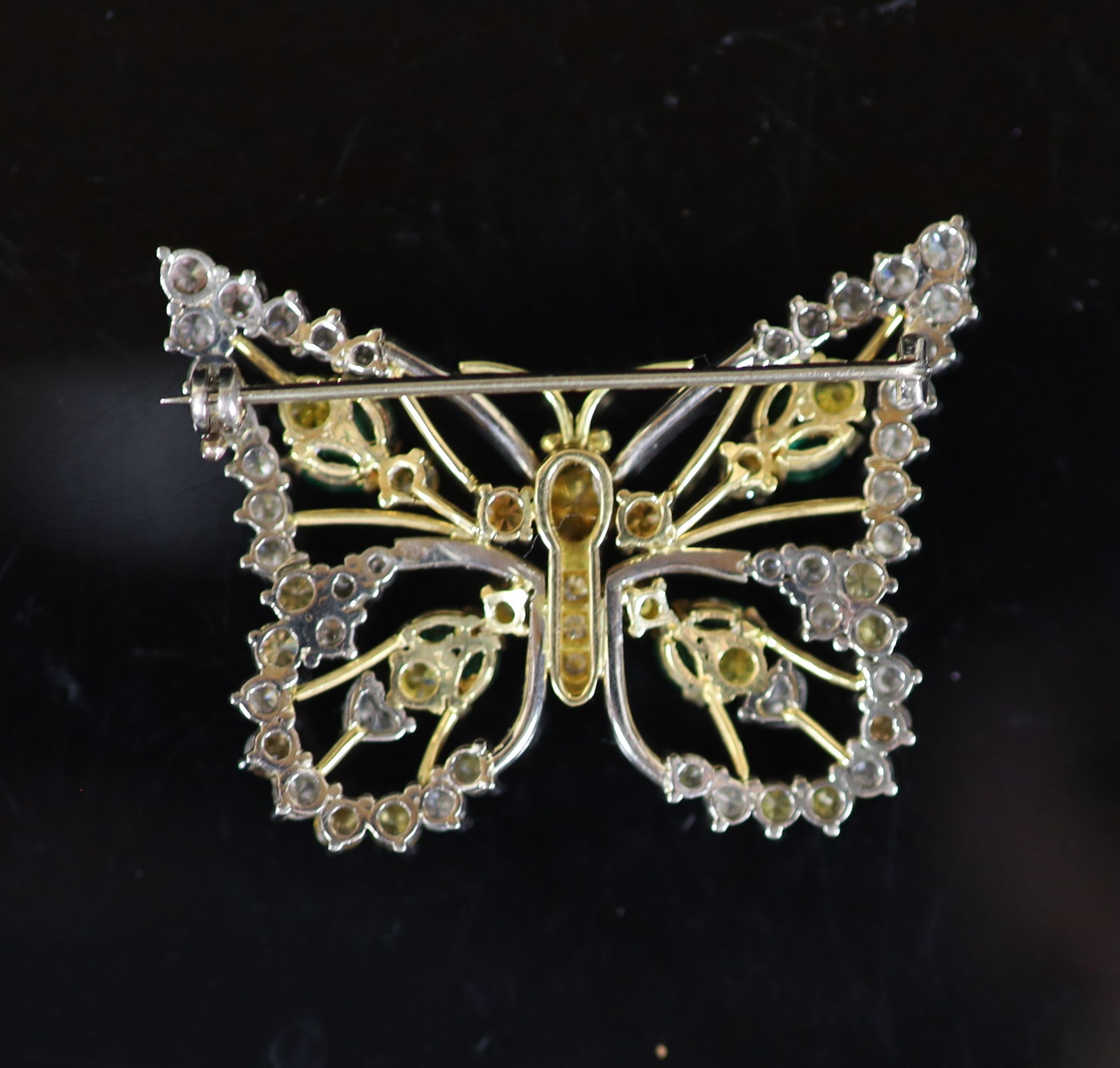 A modern white and yellow gold, diamond, emerald and citrine set open work butterfly brooch